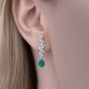 yuvarlak pırlanta dizilimli damla kesim zümrüt taşlı sallantılı küpe kulakta duruşu